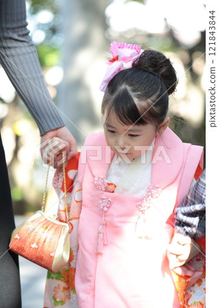 A 3-year-old girl, her 9-year-old sister and her mother visit a shrine for the Shichigosan festival. A 3-year-old girl, her 9-year-old sister and her mother visit a shrine for the Shichigosan festival. 121843844