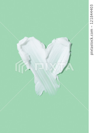 White beauty cream smear smudge isolated. Beauty skincare cream texture swipe swatch in heart shaped White beauty cream smear smudge isolated. Beauty skincare cream texture swipe swatch in heart shaped 121844403