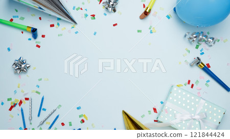 Concept of festive birthday celebrations. Birthday attributes colorful balloons, party hats, candles, confetti 121844424