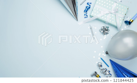 Concept of festive birthday celebrations. Birthday attributes colorful balloons, party hats, candles, confetti Concept of festive birthday celebrations. Birthday attributes colorful balloons, party hats, candles, confetti 121844425