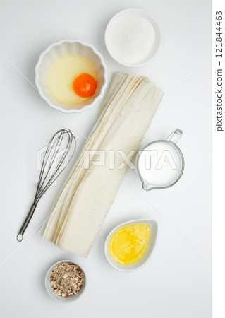 Baking Crinkle Cake ingredients, phyllo dough, egg, butter, nuts, milk 121844463