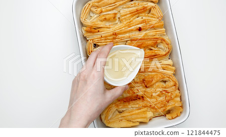 Finished Crinkle Cake with sugar syrup  made from phyllo dough glazed 121844475