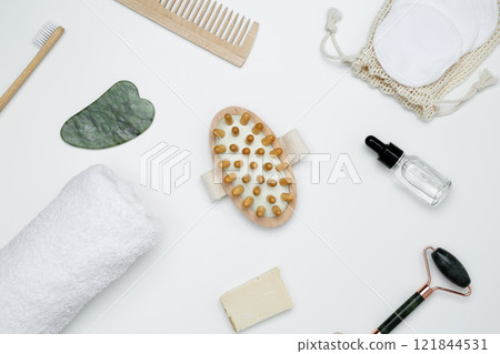 Eco-friendly beauty products: massage brush, marble roller, towel, reusable cotton pads, sustainable self-care concept 121844531