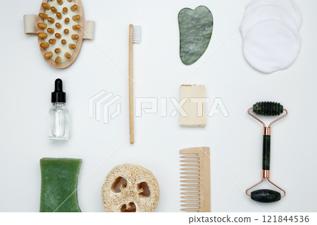 Eco-friendly beauty essentials, including soap, bamboo toothbrush, loofah sponge, marble face roller, embodying a sustainable self-care concept Eco-friendly beauty essentials, including soap, bamboo toothbrush, loofah sponge, marble face roller, embodying a sustainable self-care concept 121844536