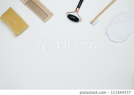 Eco-friendly beauty essentials, including bamboo toothbrush, marble face roller, embodying a sustainable self-care concept Eco-friendly beauty essentials, including bamboo toothbrush, marble face roller, embodying a sustainable self-care concept 121844537