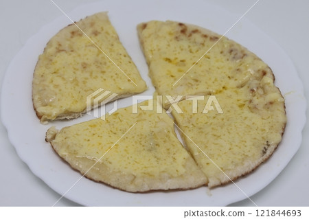 Pita bread with cottage cheese and greens on a white background. Pita bread with cottage cheese and greens on a white background. 121844693