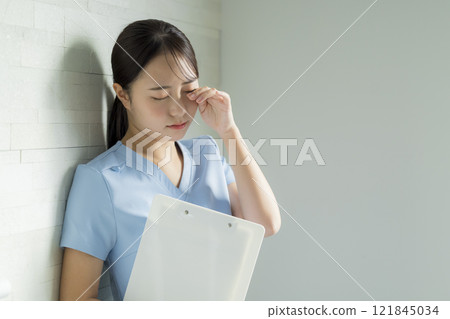 Nurse with tired expression Nurse with tired expression 121845034