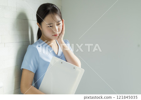 Nurse with tired expression Nurse with tired expression 121845035