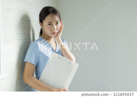 Nurse with tired expression Nurse with tired expression 121845037