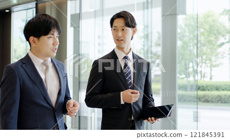 Businessman giving instructions while walking 121845391