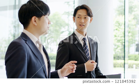 Businessman giving instructions while walking 121845392