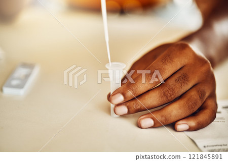 Pandemic, corona and covid home test for virus, disease and illness during lockdown inside. Closeup of hand using medical tools for an antigen test on table, feeling scared, stressed and anxious 121845891