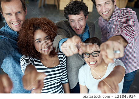 Happy, fun and smiling group of office colleagues pointing and looking cheerful in a corporate office. Diverse group of business people looking cheerful and joyful while making a hand gesture at work Happy, fun and smiling group of office colleagues pointing and looking cheerful in a corporate office. Diverse group of business people looking cheerful and joyful while making a hand gesture at work 121845924