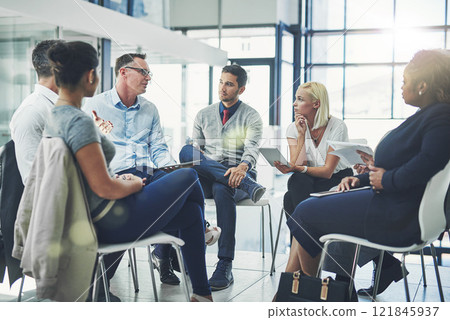 Modern business people in an informal team building discussion or business talking session. Team leader, manager or supervisor talking to a group of employees or colleagues on new workflow management Modern business people in an informal team building discussion or business talking session. Team leader, manager or supervisor talking to a group of employees or colleagues on new workflow management 121845937