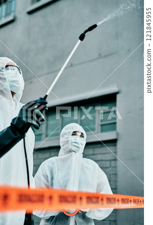 Healthcare workers wearing hazmat suits disinfecting a building during covid pandemic. First responders spraying virus protection sanitizer or cleaning to prevent the spread of germs and for hygiene 121845955