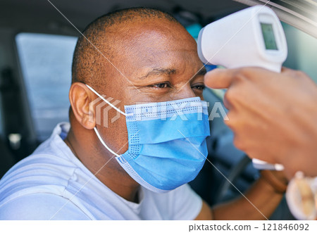 Fever, temperature and Covid test at drive through station in a car. Screening patient with protective mask with a digital thermometer. Wellness and safety of people through a pandemic 121846092