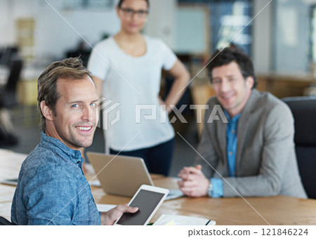 Chairman, boss or Ceo looking confident, happy and cheerful during a meeting while browsing on a digital tablet in an office. Businessman feeling positive and proud after a team planning session Chairman, boss or Ceo looking confident, happy and cheerful during a meeting while browsing on a digital tablet in an office. Businessman feeling positive and proud after a team planning session 121846224