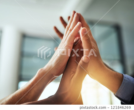 High five of a diverse group of businesspeople celebrate, unite and support each other. Closeup of a multiethnic corporate professional team hands touching showing success inside a startup office High five of a diverse group of businesspeople celebrate, unite and support each other. Closeup of a multiethnic corporate professional team hands touching showing success inside a startup office 121846269