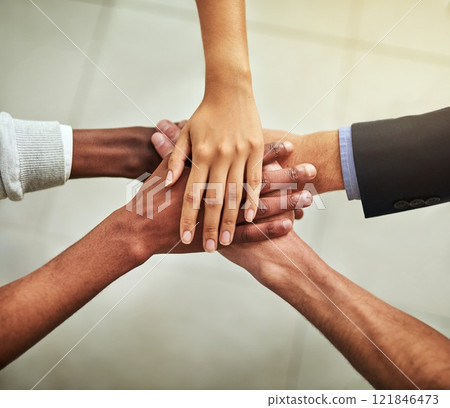 Hands of business people stacked together in group for unity, teamwork and motivation. Team of office workers, employees and colleagues piling and stacking hands for support, trust and victory 121846473