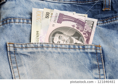 North Korean won  in the pocket of blue jeans 121846481