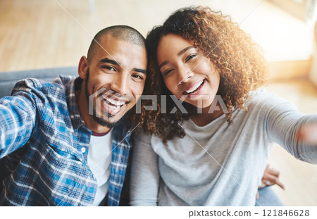 POV of a smiling couple taking selfie photo together for memories of a romantic relationship while looking happy and relaxed. Face of a young dating boyfriend and girlfriend taking a portrait picture 121846628