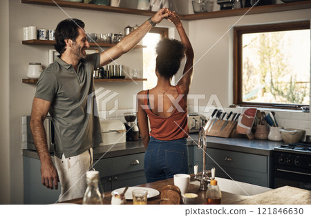 Happy, romantic and interracial couple dancing and having fun while bonding in kitchen at home. Carefree and energetic loving couple feeling cheerful while sharing a dance and enjoying time together Happy, romantic and interracial couple dancing and having fun while bonding in kitchen at home. Carefree and energetic loving couple feeling cheerful while sharing a dance and enjoying time together 121846630