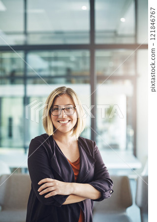 Confident manager, leader and creative boss with her arms crossed in a powerful, assertive and proud stance. Portrait of smiling, happy and business woman ready for success with arms folded in office 121846767