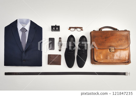 Flatlay of business suit, corporate formal attire with fashion accessories on a white table background. Still life above view of modern clothing style with phone for a professional and neat lifestyle 121847235