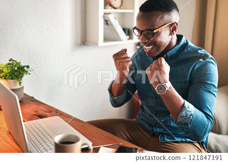 Creative entrepreneur with a laptop celebrating, cheering and feeling excited after reading email with good news. Happy, smiling and successful freelancer working from home on technology for startup 121847391