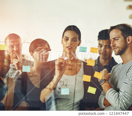 Teamwork, unity and thinking group of business people working on a project together. Discovery, innovation by creative team planning and brainstorming, sharing ideas and writing on sticky notes 121847447