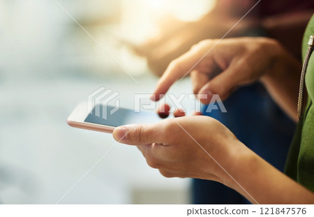 Closeup of hands of a corporate business person typing on a phone while standing in an office. Top view of a professional scrolling through social media, checking and reading texts and sending emails 121847576