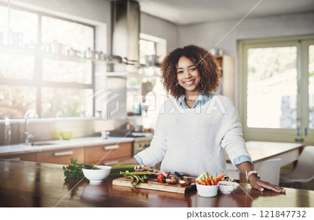 Wellness, cooking and a healthy lifestyle at home with a happy woman starting a weight loss journey. Portrait of a female smiling preparing a nutritious meal with organic vegetables in a kitchen Wellness, cooking and a healthy lifestyle at home with a happy woman starting a weight loss journey. Portrait of a female smiling preparing a nutritious meal with organic vegetables in a kitchen 121847732