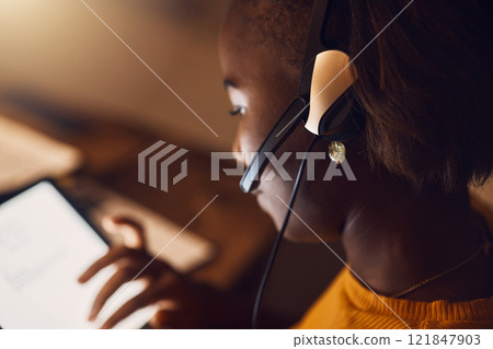 Young student browsing, learning online and searching the web at night on a tablet. Woman watching educational videos with headset, reading from the internet and participating in an online class Young student browsing, learning online and searching the web at night on a tablet. Woman watching educational videos with headset, reading from the internet and participating in an online class 121847903