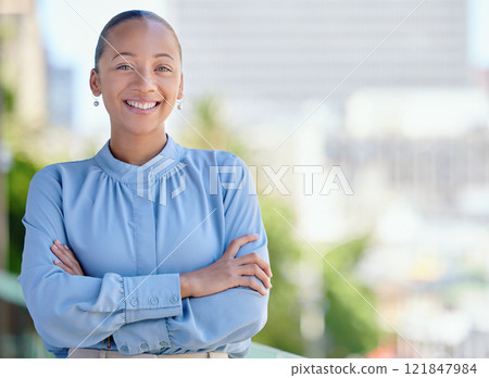 Happy, confident and smiling business woman standing with arms crossed outside at work alone. Portrait of the face of one cheerful, joyful and proud female corporate professional with arms folded 121847984
