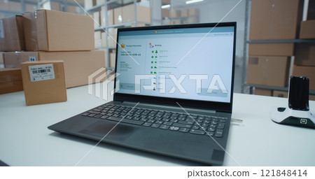 Logistics Specialist Scans Code to Check Parcel Routing on Laptop in Delivery Tracking Software Logistics Specialist Scans Code to Check Parcel Routing on Laptop in Delivery Tracking Software 121848414