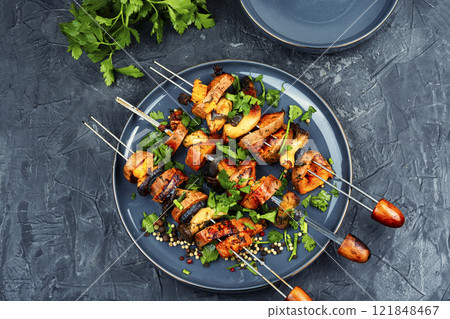 Roasted sweet potato on skewers. 121848467
