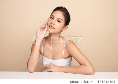 Beautiful young asian woman with clean fresh skin on beige background, Face care, Facial treatment, Cosmetology, beauty and spa, Asian women portrait. 121848504