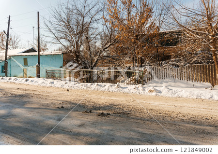 uncleaned roads after a winter snowfall in Kazakhstan. highway covered with sticky snow in Shymkent 121849002