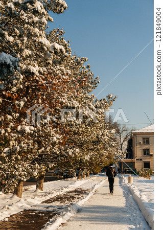 a sidewalk covered with snow in Kazakhstan. pedestrian sidewalk full of snow in Shymkent a sidewalk covered with snow in Kazakhstan. pedestrian sidewalk full of snow in Shymkent 121849004