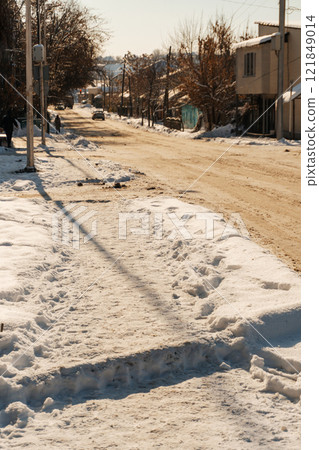 uncleaned roads after a winter snowfall in Kazakhstan. highway covered with sticky snow in Shymkent 121849014