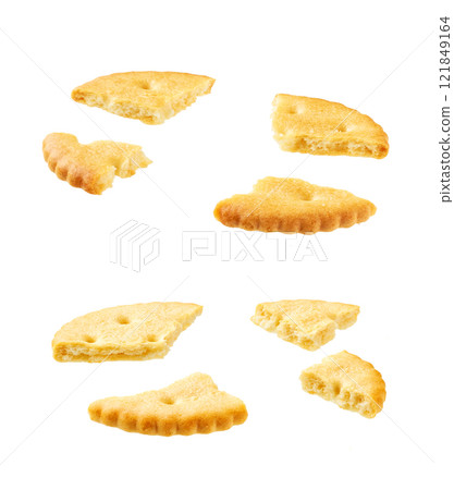 Broken round crackers isolated on white background. Broken round crackers isolated on white background. 121849164