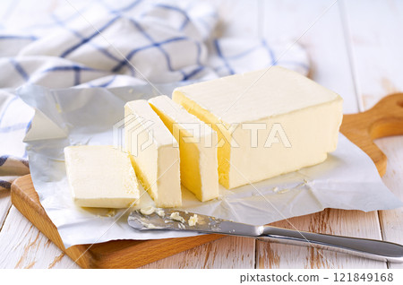 Sliced pieces of butter on a light table, selective focus. Piece of butter. 121849168
