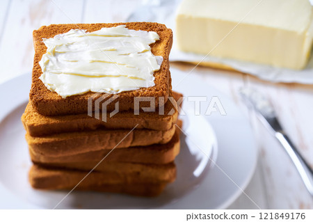 Stack of sandwich bread slices with butter, selective focus. 121849176