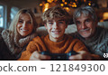Happy family of three sitting on a cozy couch with warm lighting, enjoying quality time together. Studio family portrait. Family and holiday concept for greeting cards and banners 121849300