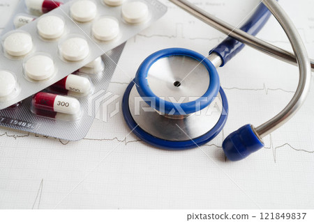 Stethoscope on electrocardiogram (ECG), heart wave, heart attack, cardiogram report. Stethoscope on electrocardiogram (ECG), heart wave, heart attack, cardiogram report. 121849837