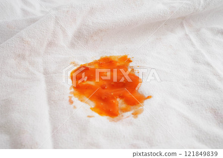 Dirty tomato sauce stain or ketchup on cloth to wash with washing powder, cleaning housework. Dirty tomato sauce stain or ketchup on cloth to wash with washing powder, cleaning housework. 121849839