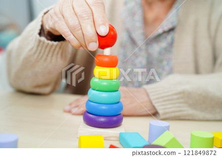 Asian elderly woman playing game. 121849872