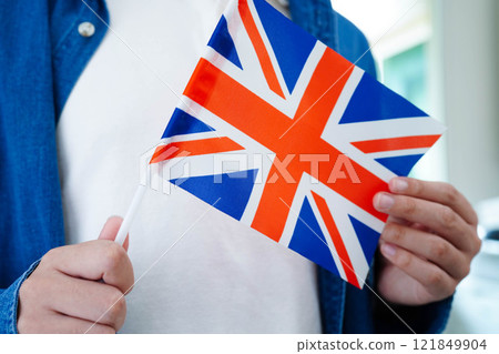 Learn English language, Asian teenage student hold book with flag in course at school. 121849904