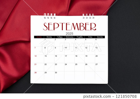 September 2025 Monthly desk calendar with red silk on black leather background. September 2025 Monthly desk calendar with red silk on black leather background. 121850708