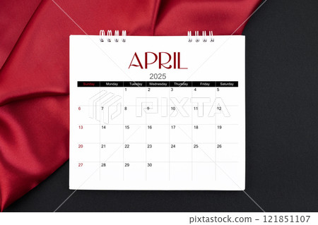 April 2025 Monthly desk calendar with red silk on black leather background. April 2025 Monthly desk calendar with red silk on black leather background. 121851107